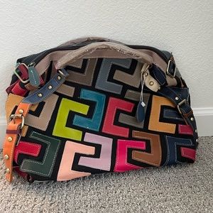 Amazon multi colored tote bag with a zip top. Patchwork leather pieces.